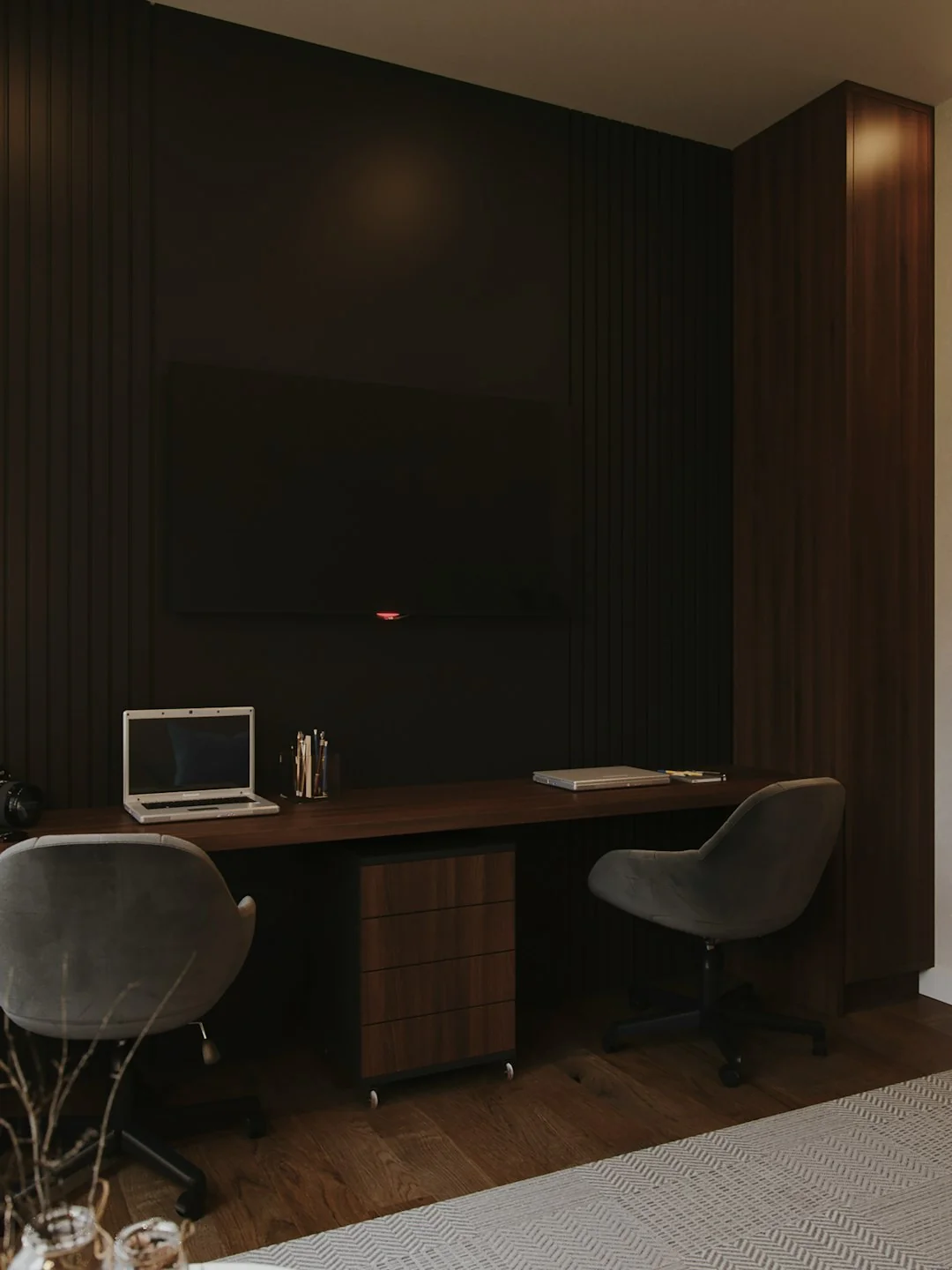A stylish workspace featuring a laptop and monitors displaying design software.